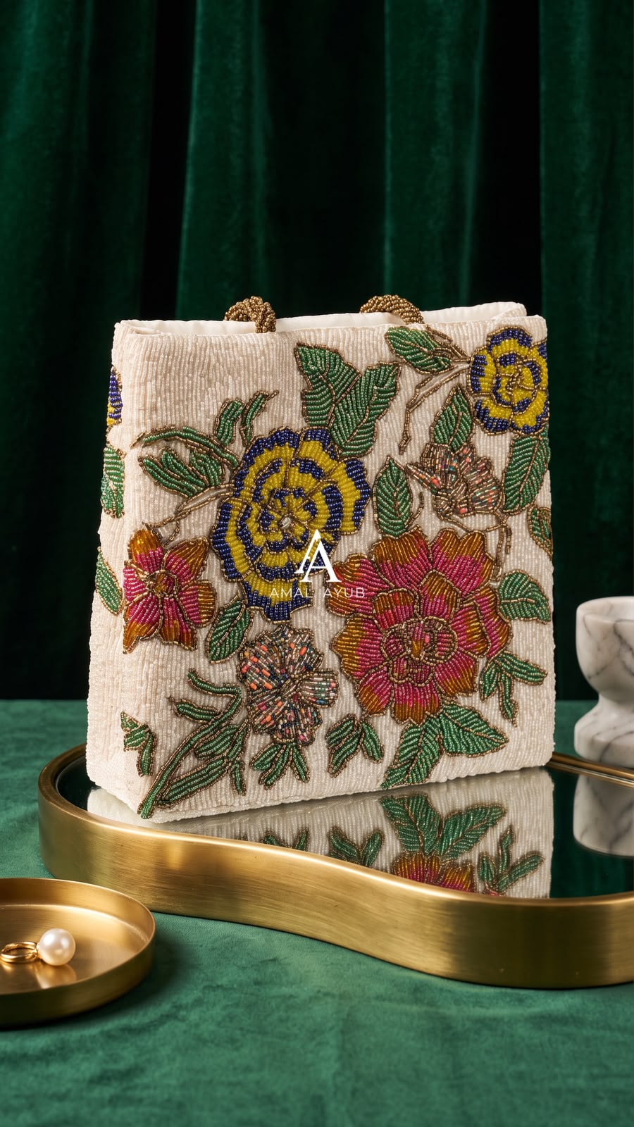 Amal Ayub ivory hand-embellished box handbag with pink, blue, and yellow floral beadwork and gold knot handle