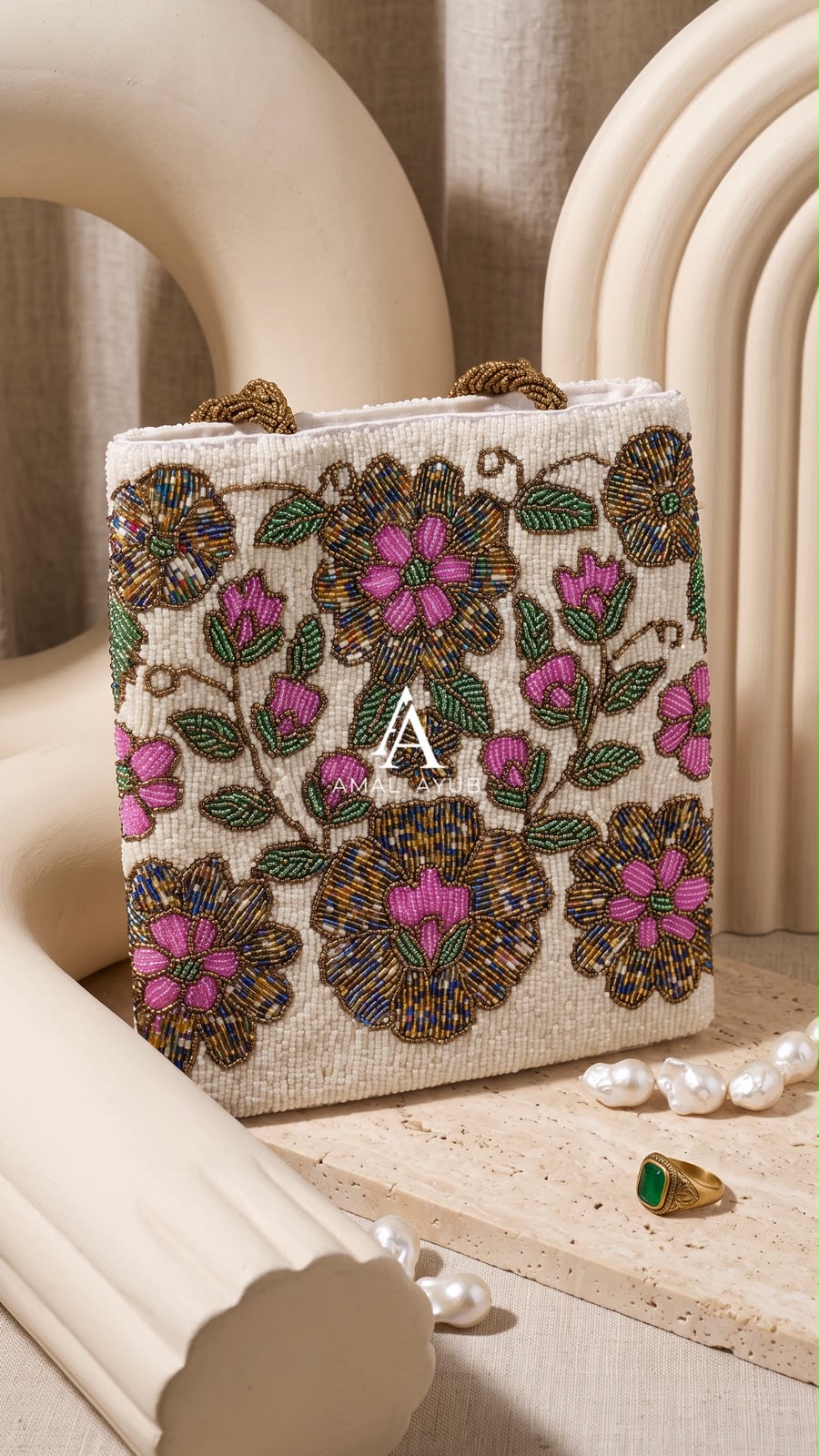 Amal Ayub ivory embellished handbag featuring handcrafted magenta and gold floral beadwork with braided gold handles