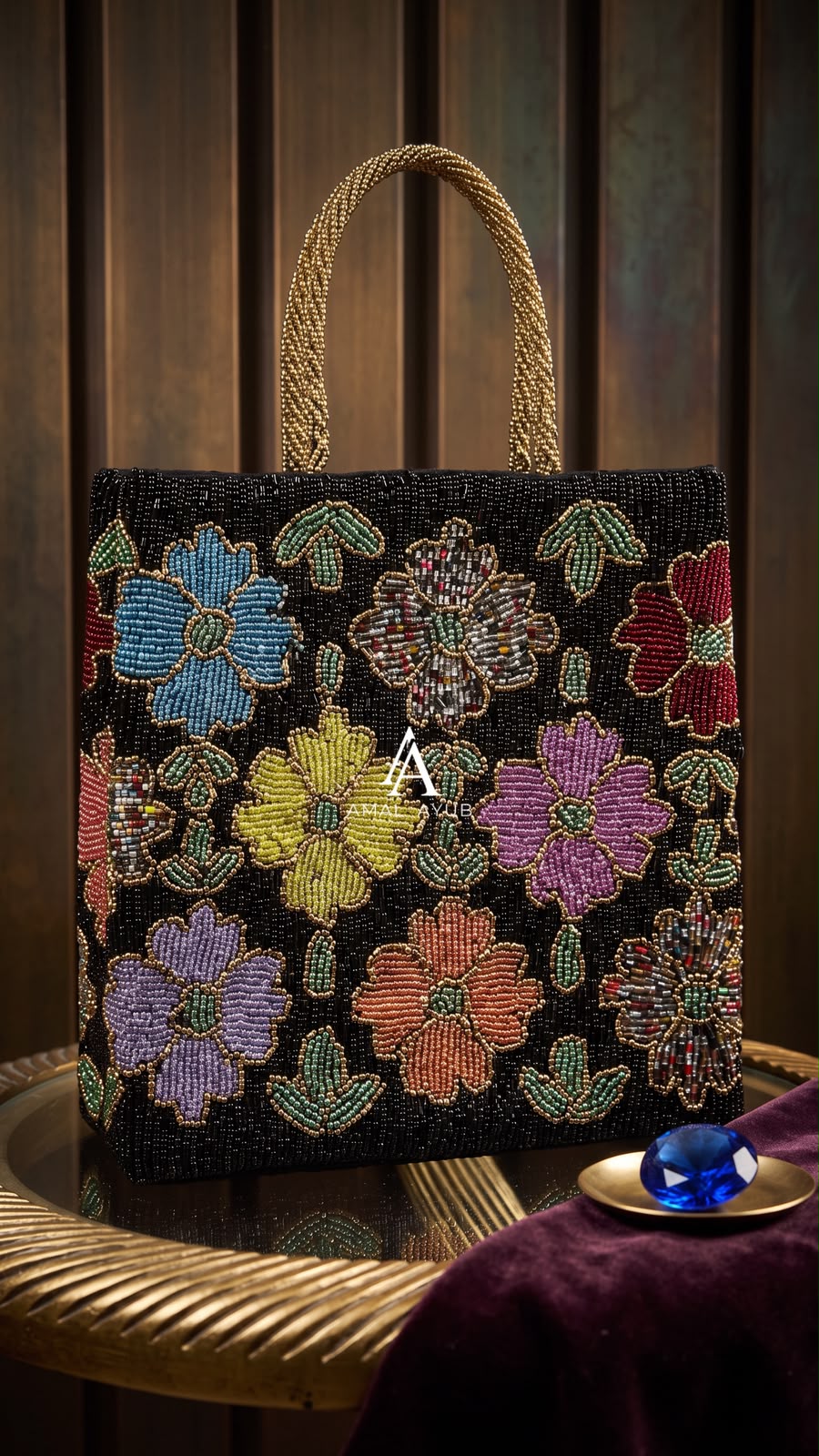 Amal Ayub handcrafted rectangular tote bag featuring colorful beaded flowers on a black glass bead canvas with gold braided top handles