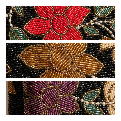 Close-up detail of Amal Ayub hand-embroidered seed bead red, gold, and purple flowers with green leaf outlines