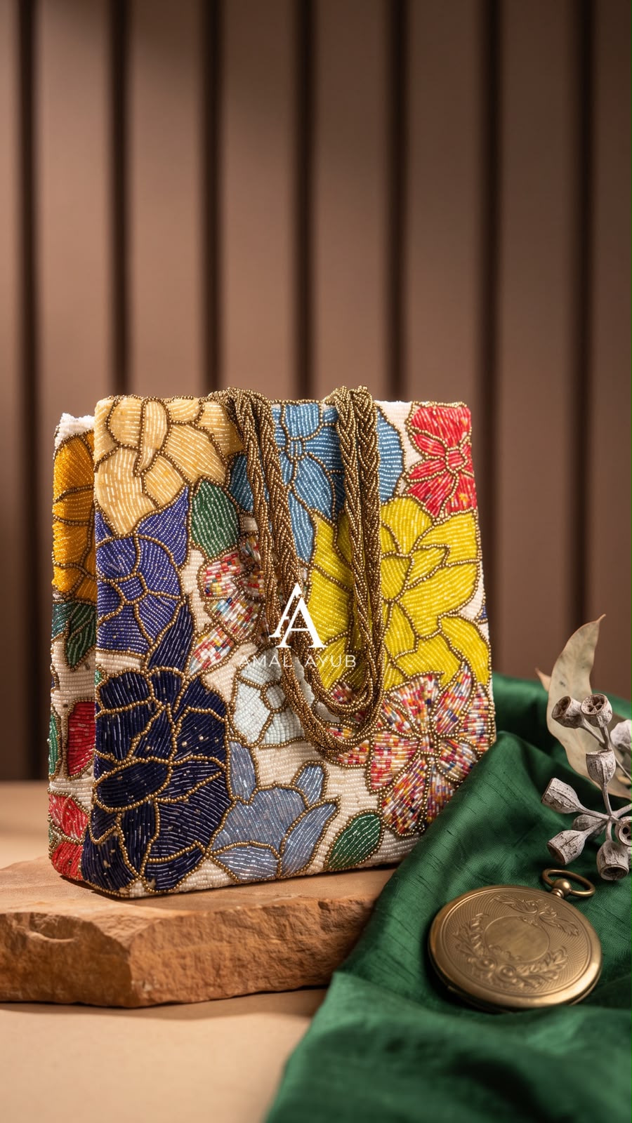 Amal Ayub ivory hand-embellished tote handbag with navy, yellow, and red floral beadwork and braided gold top handles