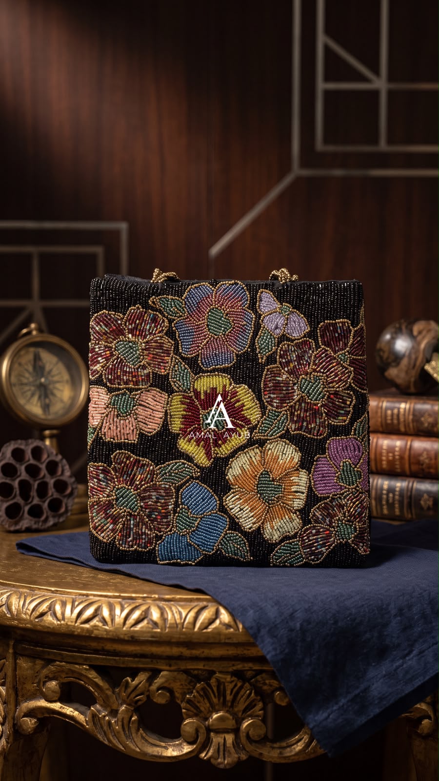 Amal Ayub black hand-embellished box handbag with maroon, mustard, and blue floral beadwork and gold knot handle