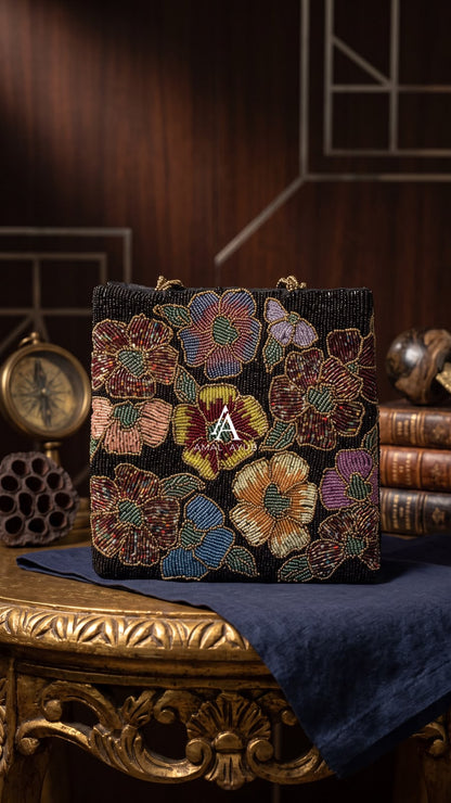 Amal Ayub black hand-embellished box handbag with maroon, mustard, and blue floral beadwork and gold knot handle
