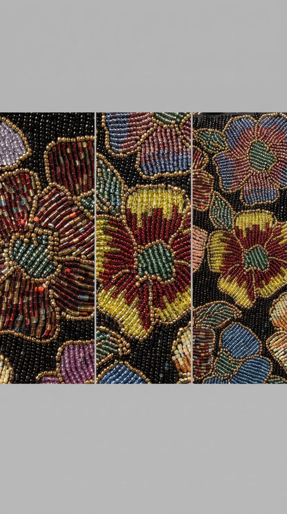 Close-up detail of Amal Ayub hand-embroidered seed bead maroon and mustard flowers with green center and gold outlining